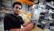 Merhawi Tesfay, an immigrant from Eritrea poses during a Reuters interview at German plant engineering firm Kremer Machine Systems where he found a job as electrician and plant manufacturer in Gescher near Muenster, Germany, August 4, 2017. Reuters/Wolfga