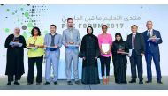 Buthaina A Al Nuaimi (centre), President of PUE, QF, alongside the recipients of the annual forum awards at the Qatar National Convention Center. 
