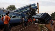 Railway workers repair the tracks next to derailed coaches of a passenger train at the site of an accident in Khatauli, in the northern state of Uttar Pradesh, India August 20, 2017. REUTERS/Adnan Abidi.