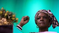 (FILES) This file photo taken on October 8, 2014 shows Zimbabwe's first lady Grace Mugabe raising her fist during a campaign meeting at the City Sports Center in Harare. AFP / Jekesai NJIKIZANA
