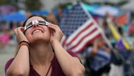 People watch the first solar eclipse to sweep across the United States in over 99 years on the beach August 21, 2017 on Hilton Head Island, South Carolina. Millions of people are expected to watch as the eclipse cuts a path of totality 70 miles wide acros
