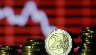 Euro coins are seen in front of a displayed stock graph in Zenica, Bosnia and Herzegovina.