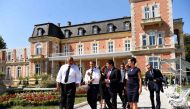 French President Emmanuel Macron (R) rolls up his sleeves as he walks along side Bulgarian Prime Minister Boyko Borissov following a press conference at the Euxinograd Palace on the Black Sea coast just north of the town of Varna on August 25, 2017. AFP /