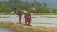 Rohingya people (back) from Rakhine state in Myanmar gather near the border in Ukhiya town, where Bangladeshi border guards were stopping them from entering, on August 25, 2017. AFP