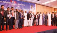 Nepali community members and other officials pose for a group picture. 