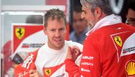 Ferrari's German driver Sebastian Vettel speaks with team principal of the Ferrari Formula One team Maurizio Arrivabene (R) during the second practice session at the Spa-Francorchamps circuit in Spa on August 25, 2017 ahead of the Belgian Formula One Gran