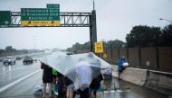 Evacuation residents from the Meyerland wait on an I-610 overpass for further help during the aftermath of Hurricane Harvey August 27, 2017 in Houston, Texas. AFP / Brendan Smialowski
