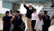 U.S. President Donald Trump (C) waves next to first lady Melania Trump upon arrival prior to receiving a briefing on Tropical Storm Harvey relief efforts in Corpus Christi, Texas, U.S., August 29, 2017. REUTERS/Carlos Barria
