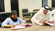 Faleh Mohammed Al Naemi (right), Chairman and CEO of Qatar Post, and Howaida Nadim, CEO of Foresight Communications, the owner of PurpleBox platform, sign the agreement at Qatar Posts headquarters yesterday. 
