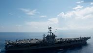 This US Navy file handout photo obtained August 30, 2017 shows an MH-60R Sea Hawk piloted by Cmdr. Paul D. Will (top), breaking formation during an aerial change of command ceremony above USS John C. Stennis (CVN 74)on May 20, 2016 in the South China Sea.