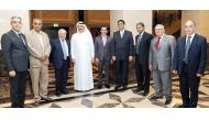 The officials of Qatar Solar Technologies pose for a photograph in front of the signature board bearing ‘Tamim Al Majd’ image. 
