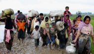 A group of Rohingya refugees walk on the muddy road after travelling over the Bangladesh-Myanmar border in Teknaf, Bangladesh, September 1, 2017. (REUTERS/Mohammad Ponir Hossain)