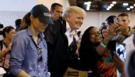 U.S. President Donald Trump poses for a photo as he and first lady Melania Trump help volunteers hand out meals during a visit with flood survivors of Hurricane Harvey at a relief center in Houston, Texas, U.S., September 2, 2017. REUTERS/Kevin Lamarque
