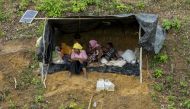 Displaced Rohingya women and children sit in a makeshift shelter in a mountain in Ukhiya, as members of the Rohingya Muslim minority fleeing unrest take shelter in a no-man's land between Bangladesh and Myanmar on September 4, 2017. AFP / K.M. Asad