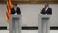 President of the Catalan regional government Carles Puigdemont (L) listens to Tunisian human rights activist Ahmed Galai during a statement to the press in Barcelona on September 4, 2017. AFP / Lluis Gene