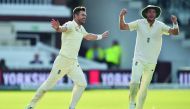 England’s James Anderson (left) celebrates with England’s Stuart Broad after taking his 500th Test match wicket of West Indies’ Kraigg Brathwaite during the second day of the third Test match at Lords cricket ground in London yesterday.