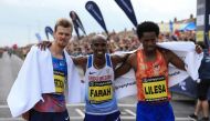 (L-R) Second-placed New Zealand's Jake Robertson, winner Britain's Mo Farah and third-placed Ethiopia's Feyisa Lilesa pose at the finish line after finishing the men's elite race of the Great North Run half-marathon in South Shields, north east England on