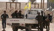 Fighters from Deir al-Zor military council which fights under the Syrian Democratic Forces (SDF) sit on a back of a truck in the village of Abu Fas, Hasaka province, Syria September 9, 2017. REUTERS/Rodi Said

