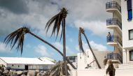 This handout photograph provided courtesy of the Dutch Department of Defense on September 8, 2017 shows a man looking on over the devastion of Hurricane Irma on the Dutch Caribbean island of Sint Maarten. AFP PHOTO / DUTCH DEFENSE MINISTRY