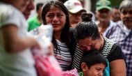 Relatives and friends accompany to the cemetery the remains of a victim of Thursday night's 8.2-magnitude quake, in Juchitan, Oaxaca, Mexico, on September 10, 2017. AFP / RONALDO SCHEMIDT