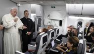 Pope Francis talks to journalists during a press conference held on board the flight to Rome, at the end of a five-day visit to Colombia, on September 11, 2017.  AFP / Andrew Medichini