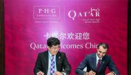 Officials from Qatar and China signing the agreement.