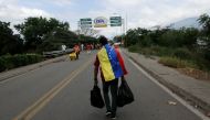 Filephoto of a man crossing the Francisco de Paula Santander international bridge, linking Urena, Venezuela, and Cucuta, Colombia. George Castellanos/AFP/Getty Images
 