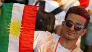 An Iraqi Kurd holds a Kurdish flag during an event to urge people to vote in the upcoming independence referendum in Arbil, the capital of the autonomous Kurdish region of northern Iraq, on September 15, 2017. AFP / SAFIN HAMED
