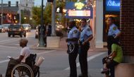 University City Police Officers stand outside a local business prior to a protest action following a not guilty verdict on September 18, 2017 in University City, Missouri. Protests have now erupted for a fourth day that have lead to vandalism and damage f