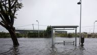 A flooded road and a bus stop are pictured on Boulevard Chanzy in downtown Pointe-a-Pitre on September 19, 2017 in the French territory of Guadeloupe after the passage of Hurricane Maria.  / AFP / Cedrick Isham CALVADOS