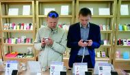 Men try out Xiaomi smartphones at the company's store in central Kiev, Ukraine May 17, 2017. REUTERS/Valentyn Ogirenko