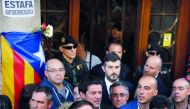 Catalan regional vice-president and chief of Economy and Finance, Oriol Junqueras talks to the people after leaving the Economy headquarters of Catalonia’s regional government during a search by Spanish Civil Guard in Barcelona, yesterday.