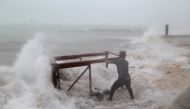A man tries to salvage a table belonging to his restaurant before the arrival of Hurricane Maria in Punta Cana, Dominican Republic, September 20, 2017. REUTERS/Ricardo Rojas
