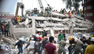Rescuers, firefighters, policemen, soldiers and volunteers search for survivors in a flattened building in Mexico City on September 20, 2017 a day after a strong quake hit central Mexico. AFP / Yuri Cortez