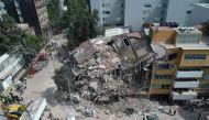 Aerial view of a flattened building in Mexico City taken on September 20, 2017 as the search for survivors continues a day after a strong quake hit central Mexico.  AFP / Mario VAZQUEZ
