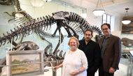From L to R: Rhoda Knight Kalt, composer John Musto and librettist Eric Einhorn pose for a picture during an interview at the Dinosaur Hall of the American Museum of Natural History in New York City on September 18, 2017. AFP / ANGELA WEISS 