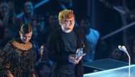 (FILES) This file photo taken on August 27, 2017 shows Ed Sheeran accepting the Artist of the Year award onstage during the MTV Video Music Awards 2017. AFP / Jean-Baptise LACROIX

