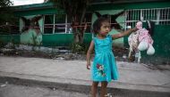 JOJUTLA, MEXICO: A girl is seen outside a collapsed primary school, 5 days after a 7.1 earthquake in Jojutla, Morelos state, Mexico on September 24, 2017. (Daniel Cardenas - Anadolu Agency)
