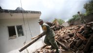 Soldiers clean the rubble on a destroyed house after an earthquake in San Juan Pilcaya, at the epicenter zone, Mexico, September 25, 2017. REUTERS/Edgard Garrido
