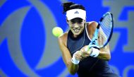 Garbine Muguruza of Spain hits a return against Lesia Tsurenko of Ukraine during their second round women’s singles match at the WTA Wuhan Open in Wuhan, China yesterday.