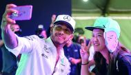 Mercedes’ British driver Lewis Hamilton (left) takes pictures during a meet the fans session in Kuala Lumpur, yesterday, ahead of the Malaysia Grand Prix. The Malaysia Grand Prix will take place on October 1.