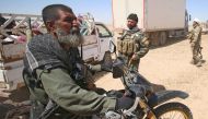 A picture taken on April 26, 2017 shows Iraqi Abu Tahsin al-Salhi (L), a veteran sniper from the Hashed al-Shaabi (Popular Mobilisation units) who boasted about killing at least 320 Islamic State (IS) group fighters, during the fight for the Iraqi city of
