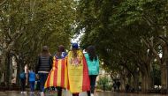 Girls stroll through the center of Figueras with the Spanish and a pro-independence 'Estelada' Catalan flag on September 30, 2017 in Figueras (AFP PHOTO / CESAR MANSO).