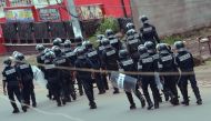 Cameroon police officials walk with riot shields on a street in the administrative quarter of Buea some 60kms west of Douala on October 1, 2017.  AFP