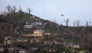 A military helicopter flight over a residential area following damages caused by Hurricane Maria near Caguas, Puerto Rico, October 1, 2017 REUTERS/Carlos Barria
