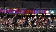 LAS VEGAS, NV - OCTOBER 01 People run from the Route 91 Harvest country music festival after apparent gun fire was heard on October 1, 2017 in Las Vegas, Nevada. There are reports of an active shooter around the Mandalay Bay Resort and Casino. David Becke