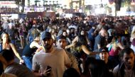 People flee the Route 91 Harvest country music festival grounds after a active shooter was reported on October 1, 2017 in Las Vegas, Nevada. David Becker/Getty Images/AFP