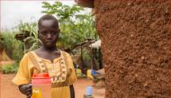 Mary, 18, shows the kind of yellow, muddy water that she and her family drink in Khor William, South Sudan, September 15, 2017. Thomson Reuters Foundation/Stefanie Glinski