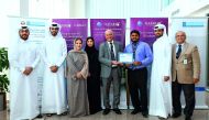 Qatar Airways and Hamad Medical Corporation (HMC) officials pose for a group picture.