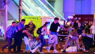 An injured person is tended to at the site of the shooting at a country music festival in Las Vegas, Nevada, yesterday.